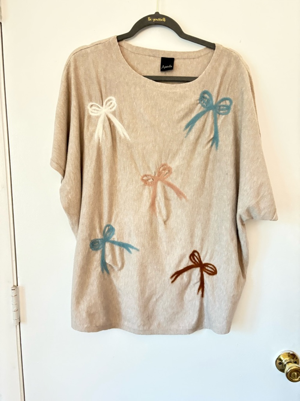 Aaeda Beige Knit Top with Bow Motif